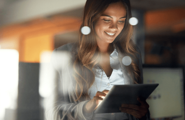 Kvinne med nettbrett smiler